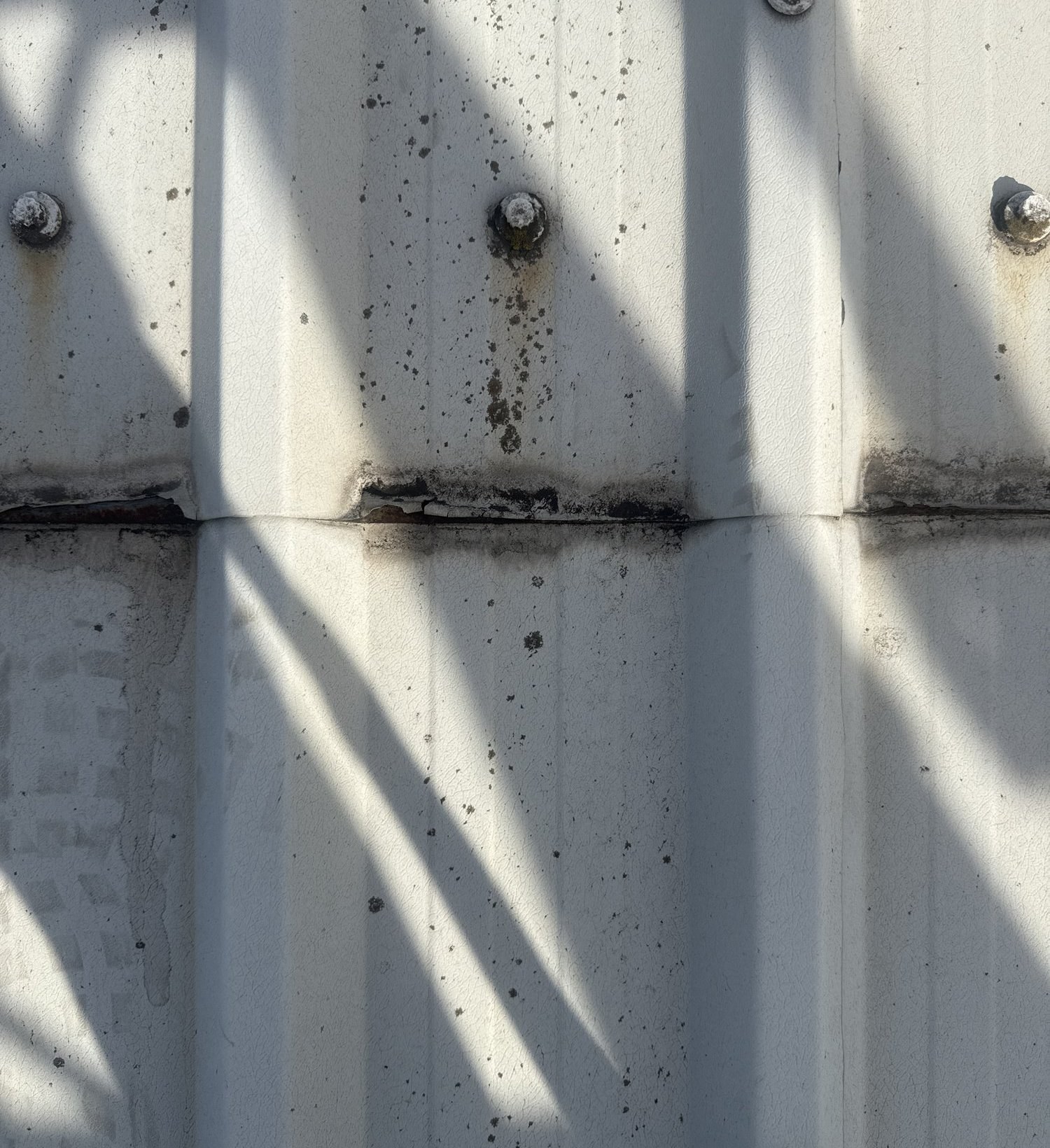 Corroded roof sheet end lap on warehouse roof